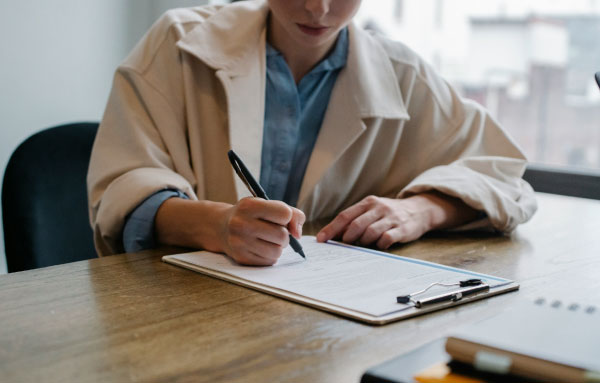 Mujer firmando contrato de su nuevo hogar familiar en Pobla de Farnals